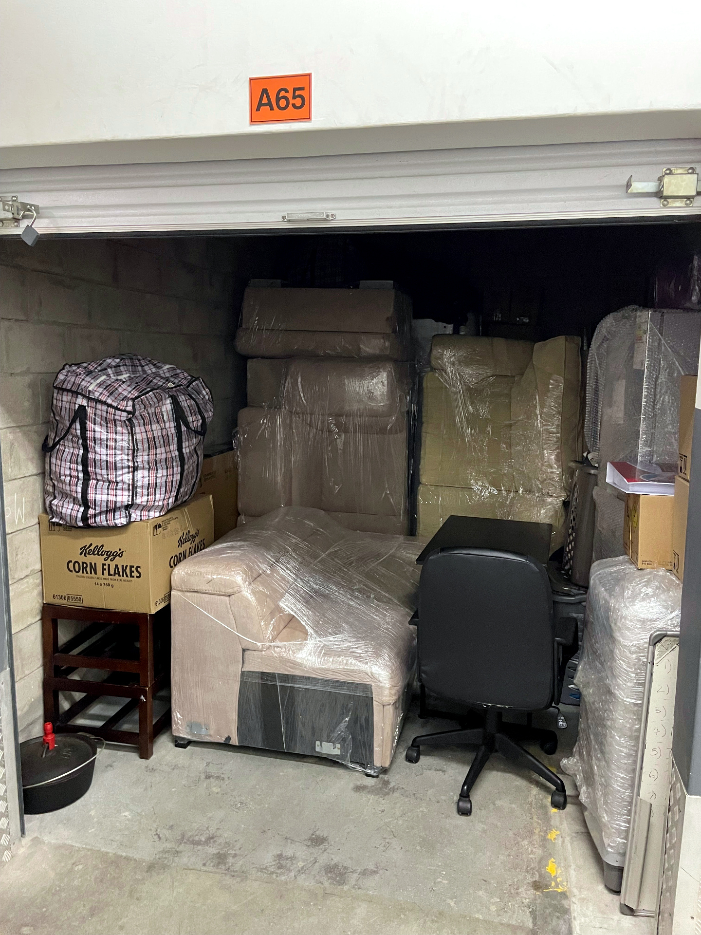 Garage full of furniture and stored household items before removal