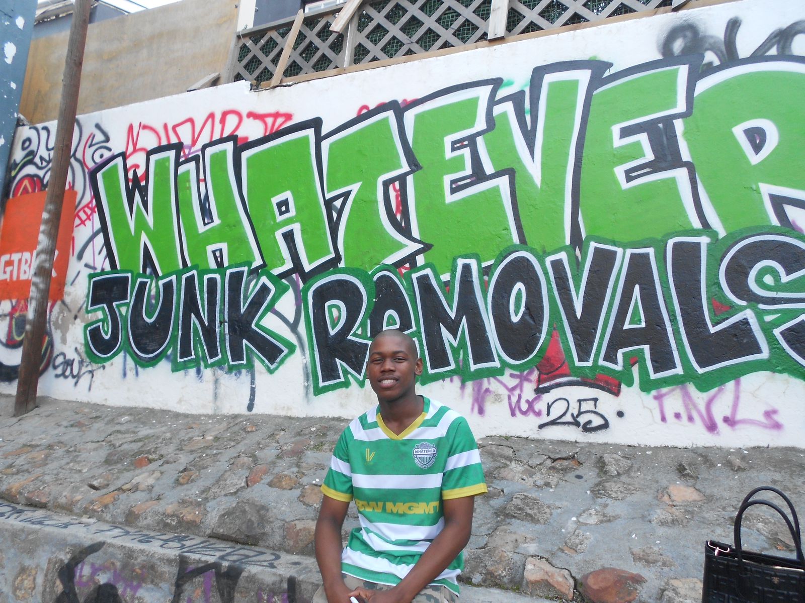 Whatever Junk Removals founder in front of company mural in Cape Town