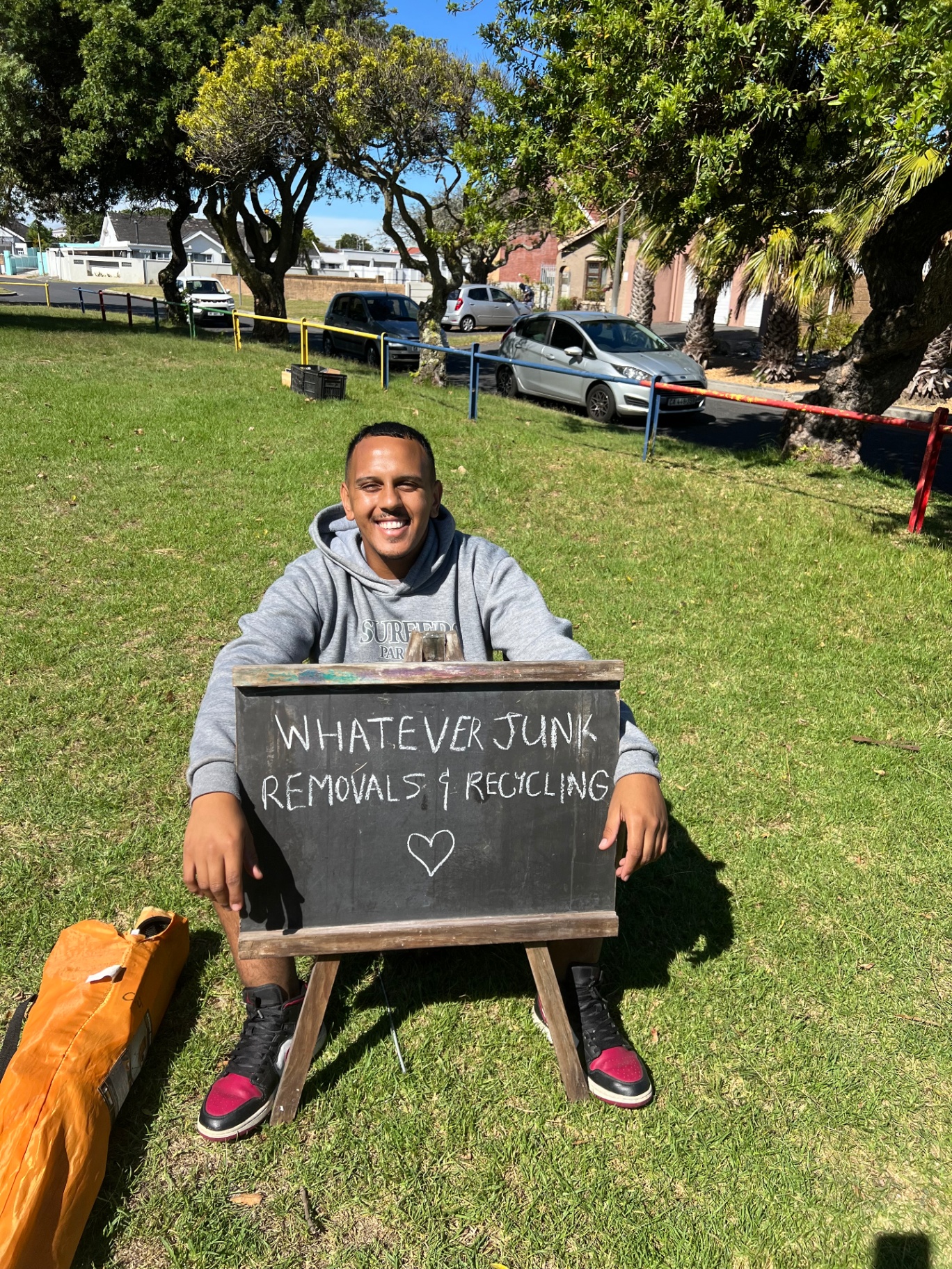 Whatever Removals & Recycling founder with company sign in Cape Town